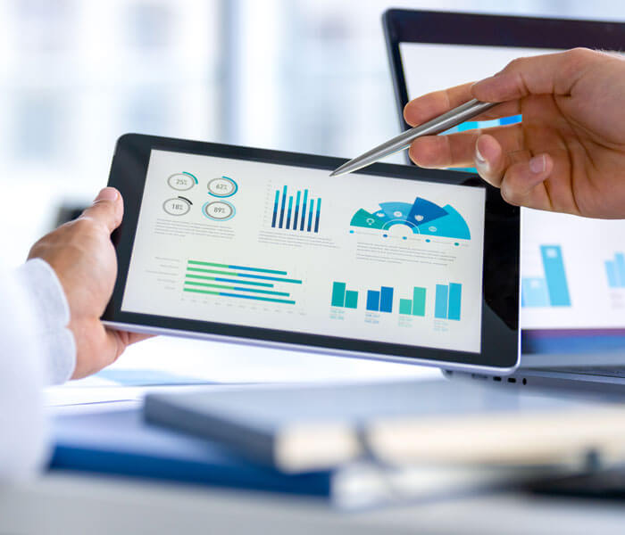 financial planner reviewing data on a tablet